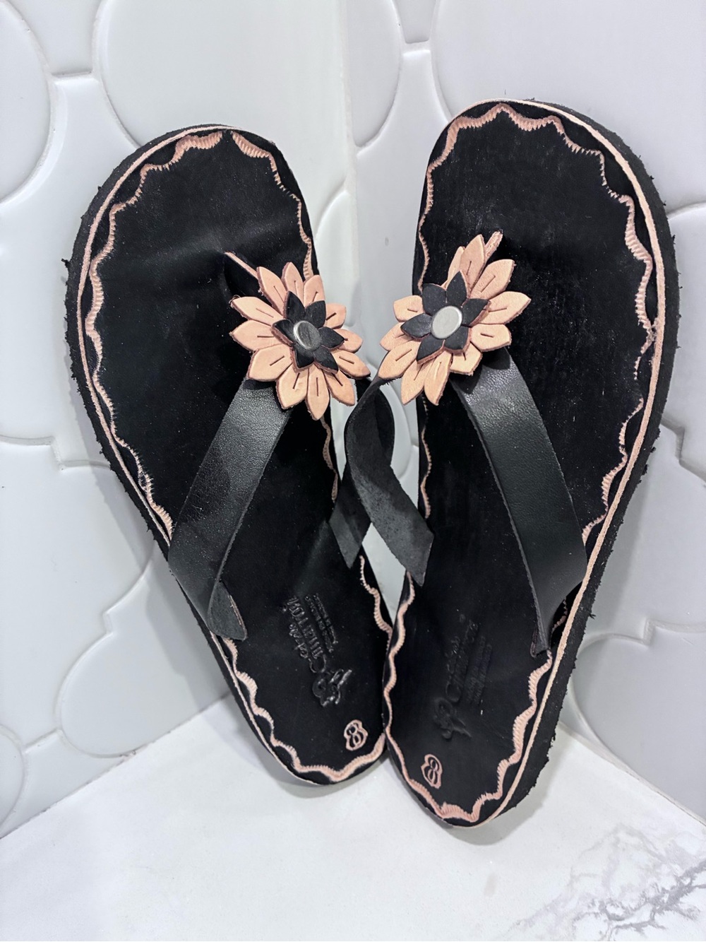 NWOT Women's Black leather Flip Flops with Flower Accent